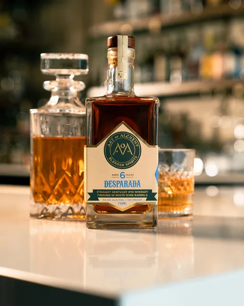 Desparada, the six-year rye finished in white wine barrels, on the bar with a decanter and a filled rocks glass.